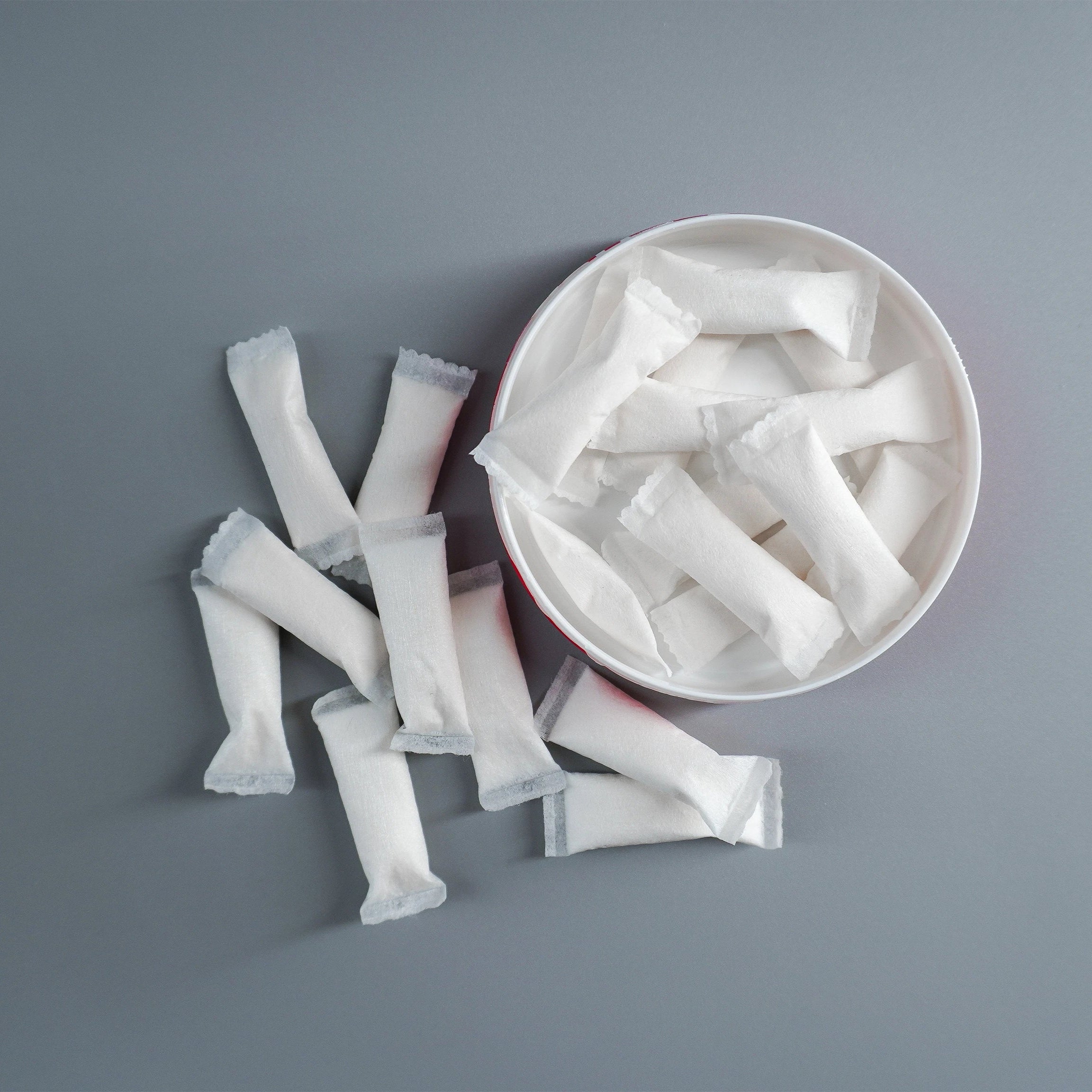 diip premium nixodine dip pouches on a gray surface pouring out of a dip pouch can