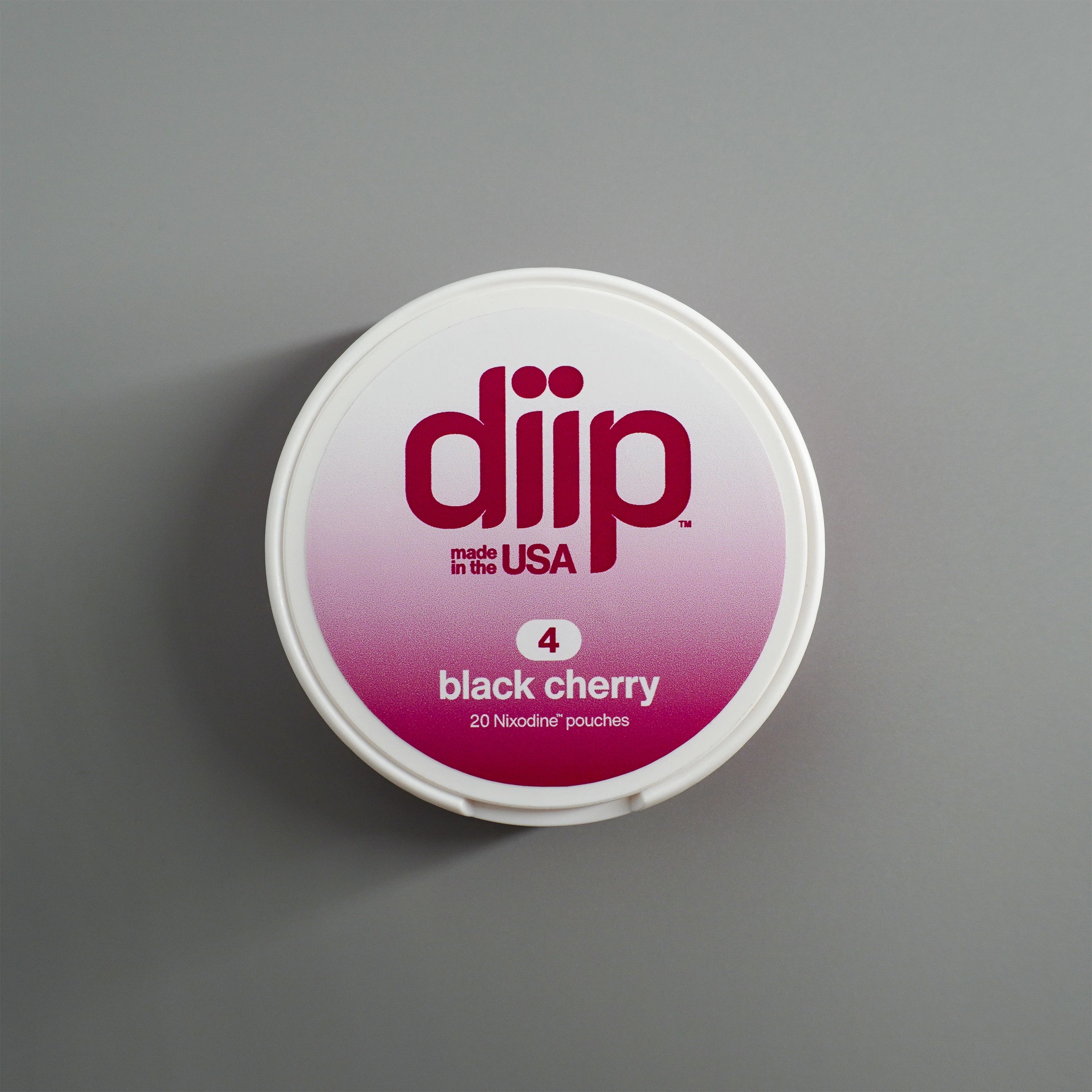 diip black cherry 4 nicotine-free dip pouch can laying on a white background