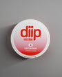 diip cinnamon 4 nicotine-free dip pouch can laying on a white background