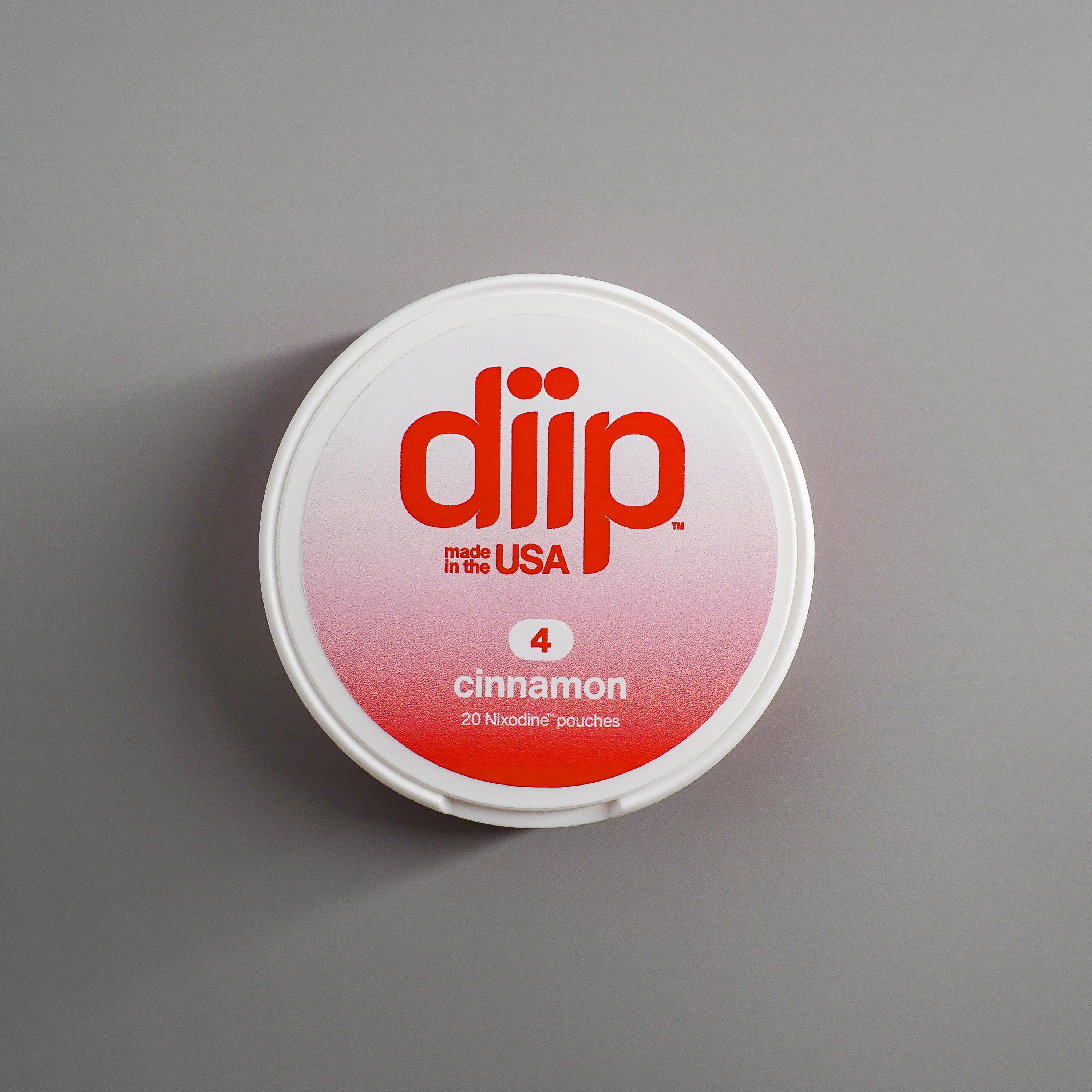 diip cinnamon 4 nicotine-free dip pouch can laying on a white background