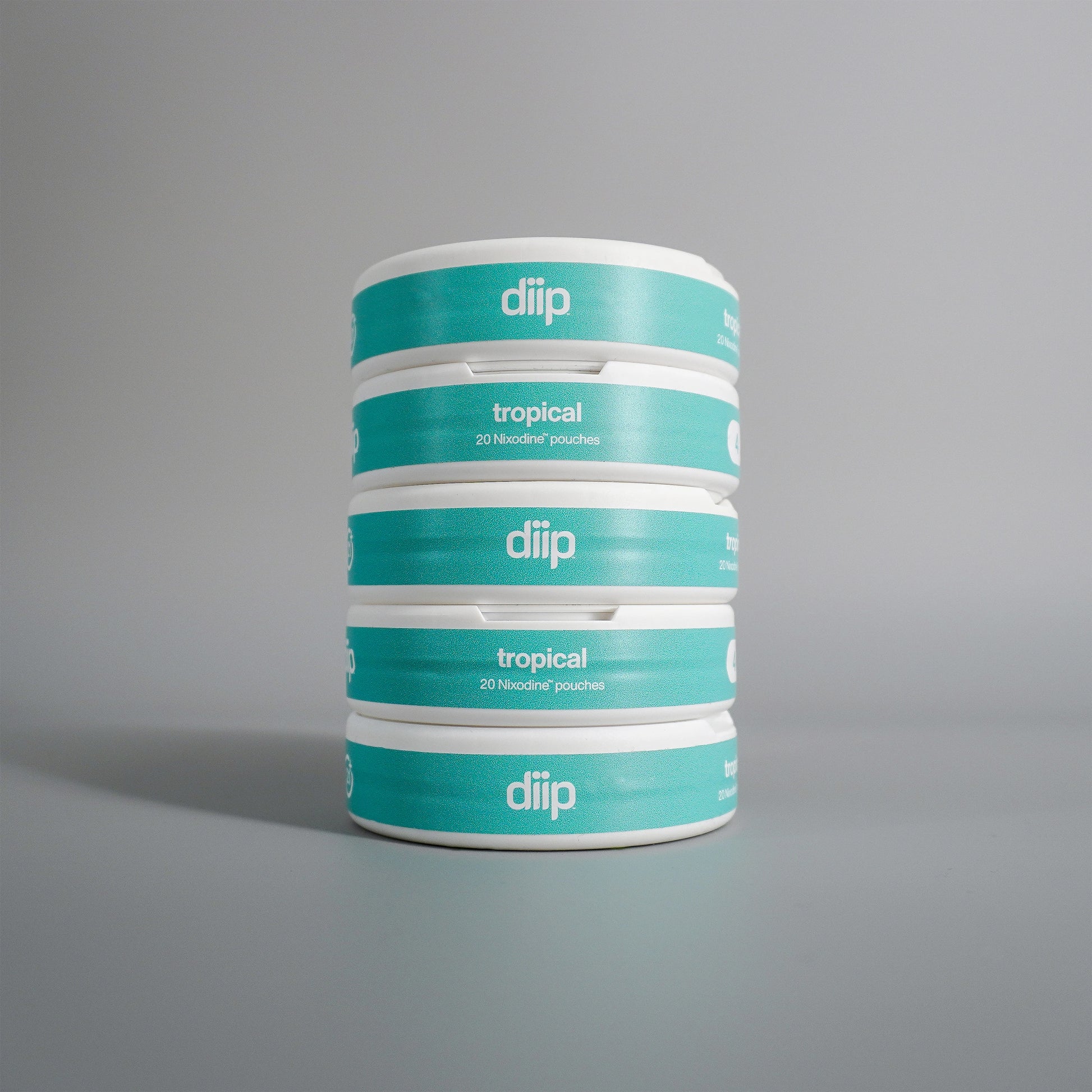 diip tropical 4 nicotine-free dip pouch cans standing upright in front of a white background