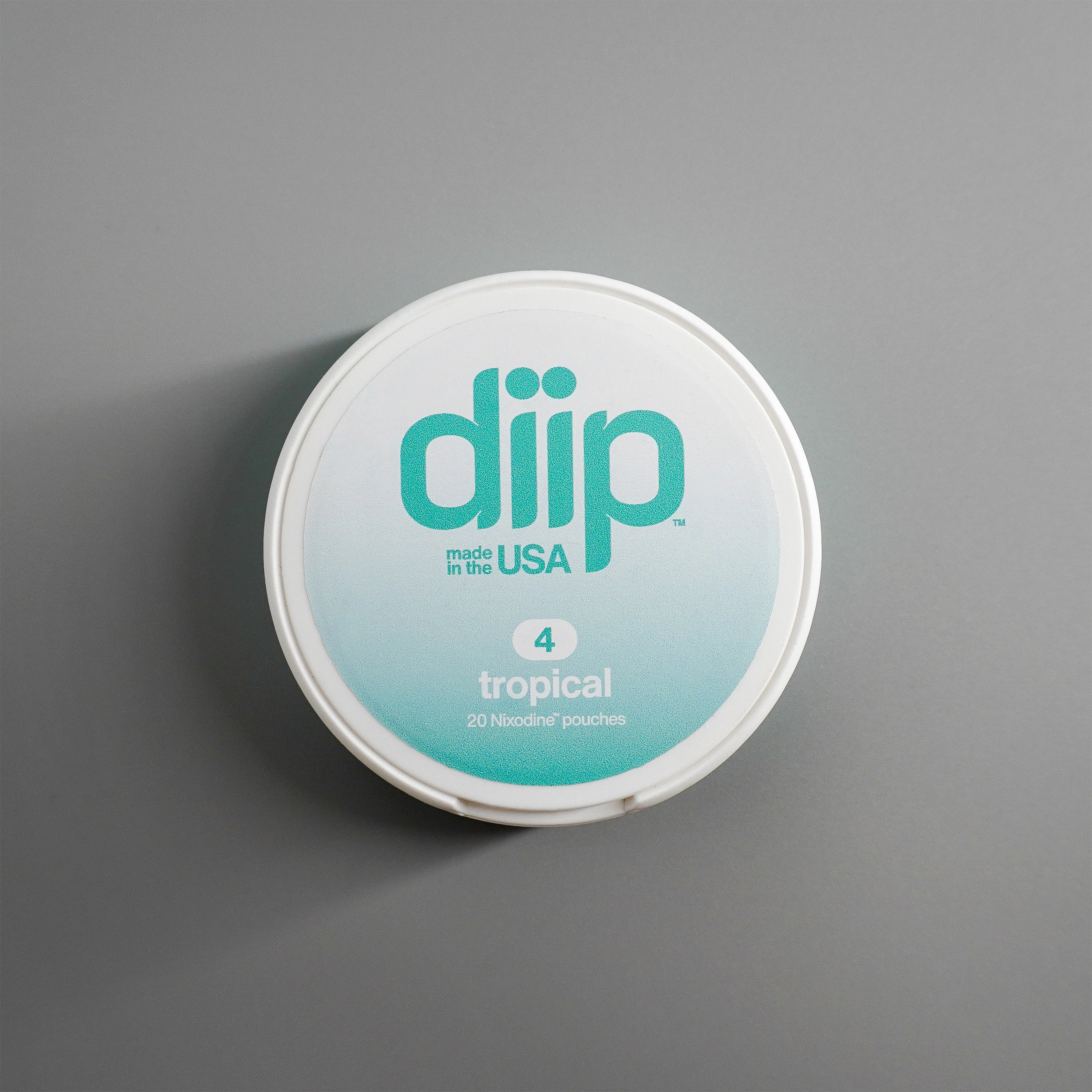 diip tropical 4 nicotine-free dip pouch can laying on  a white background