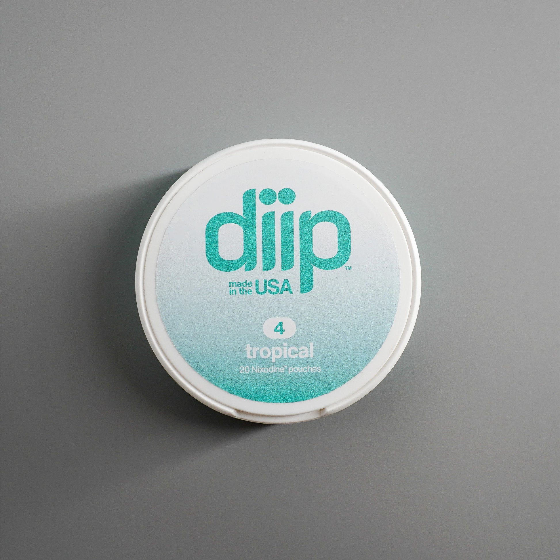 diip tropical 4 nicotine-free dip pouch can laying on  a white background