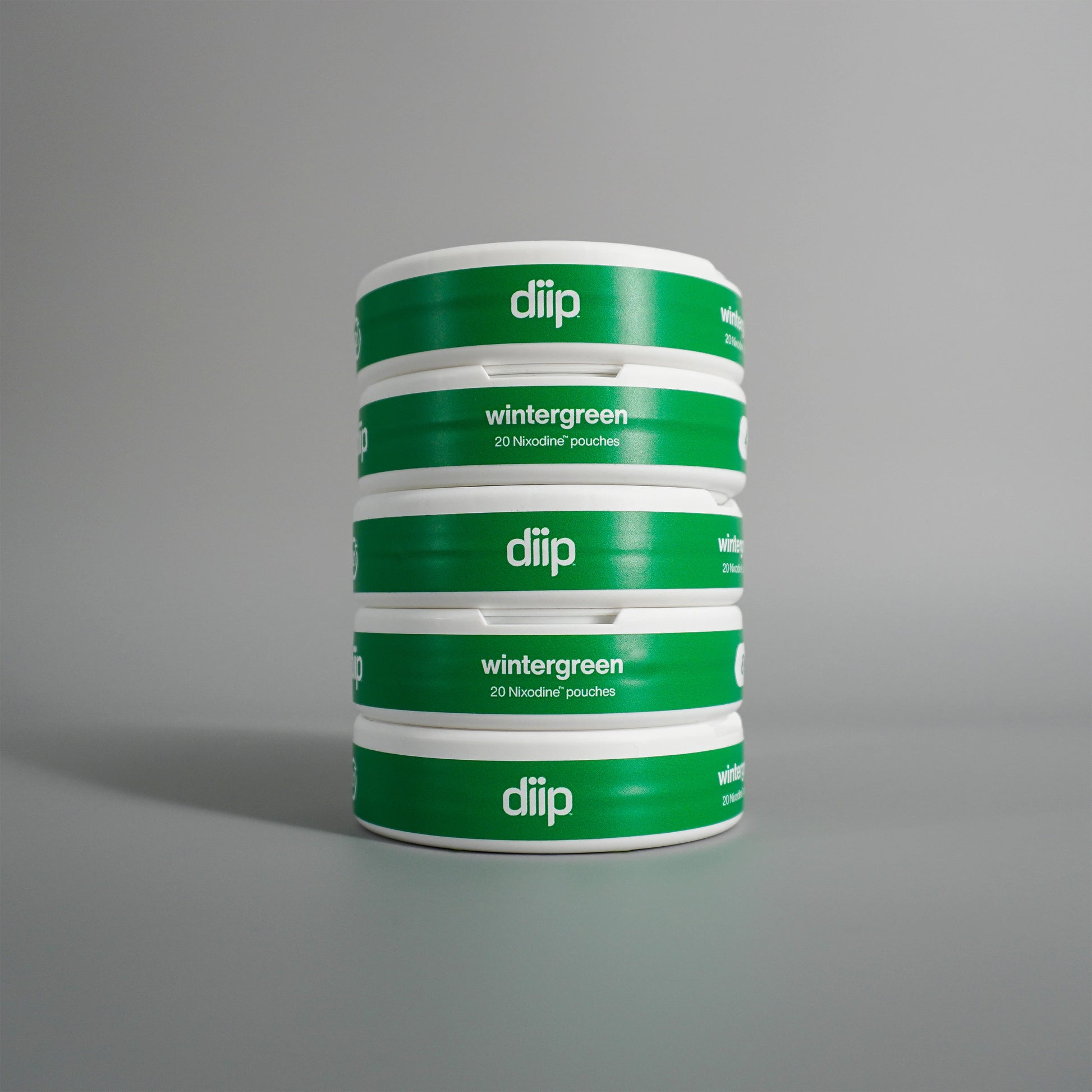 diip wintergreen 4 nicotine-free dip pouch cans standing upright in front of a white background