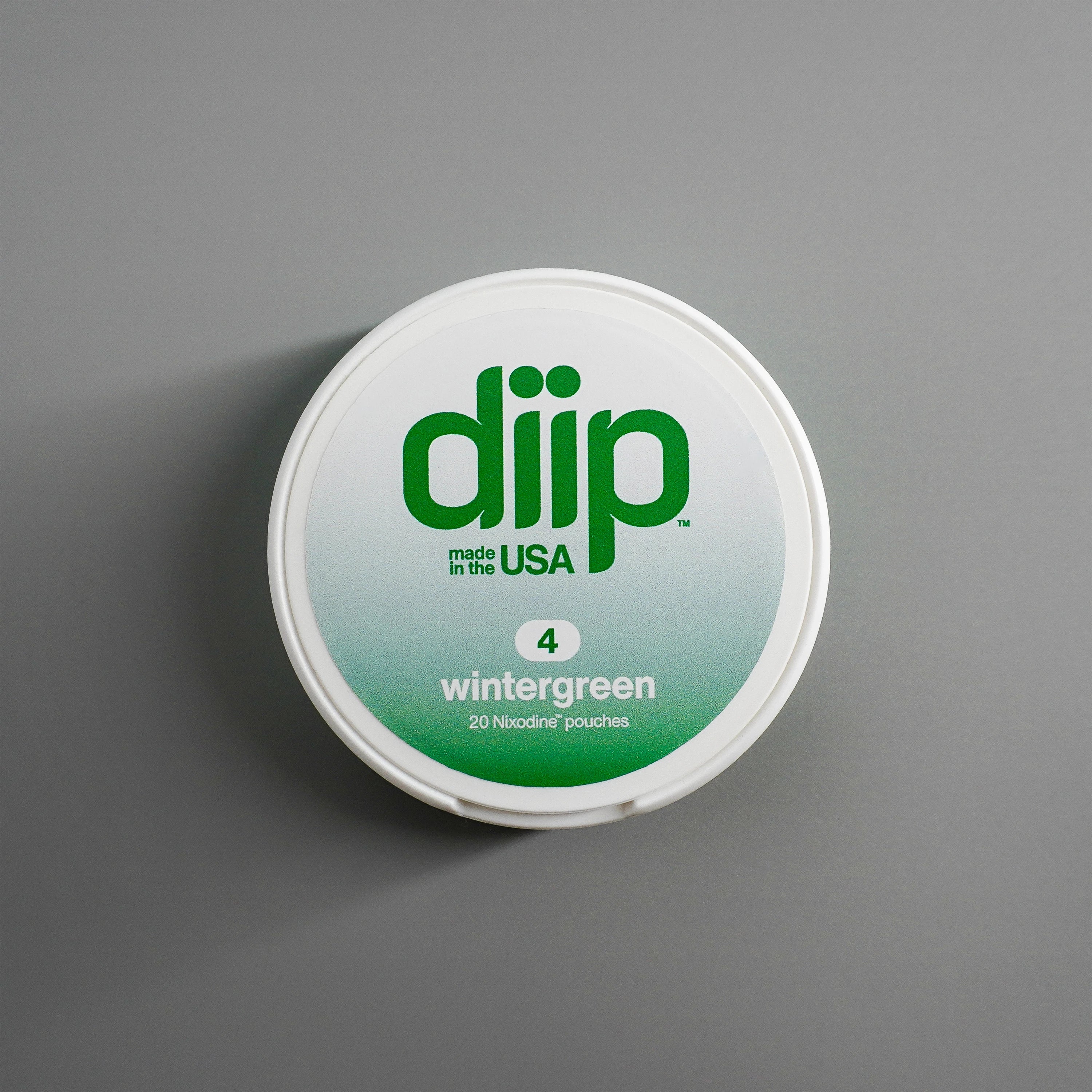 diip wintergreen 4 nicotine-free dip pouch can laying on a white background