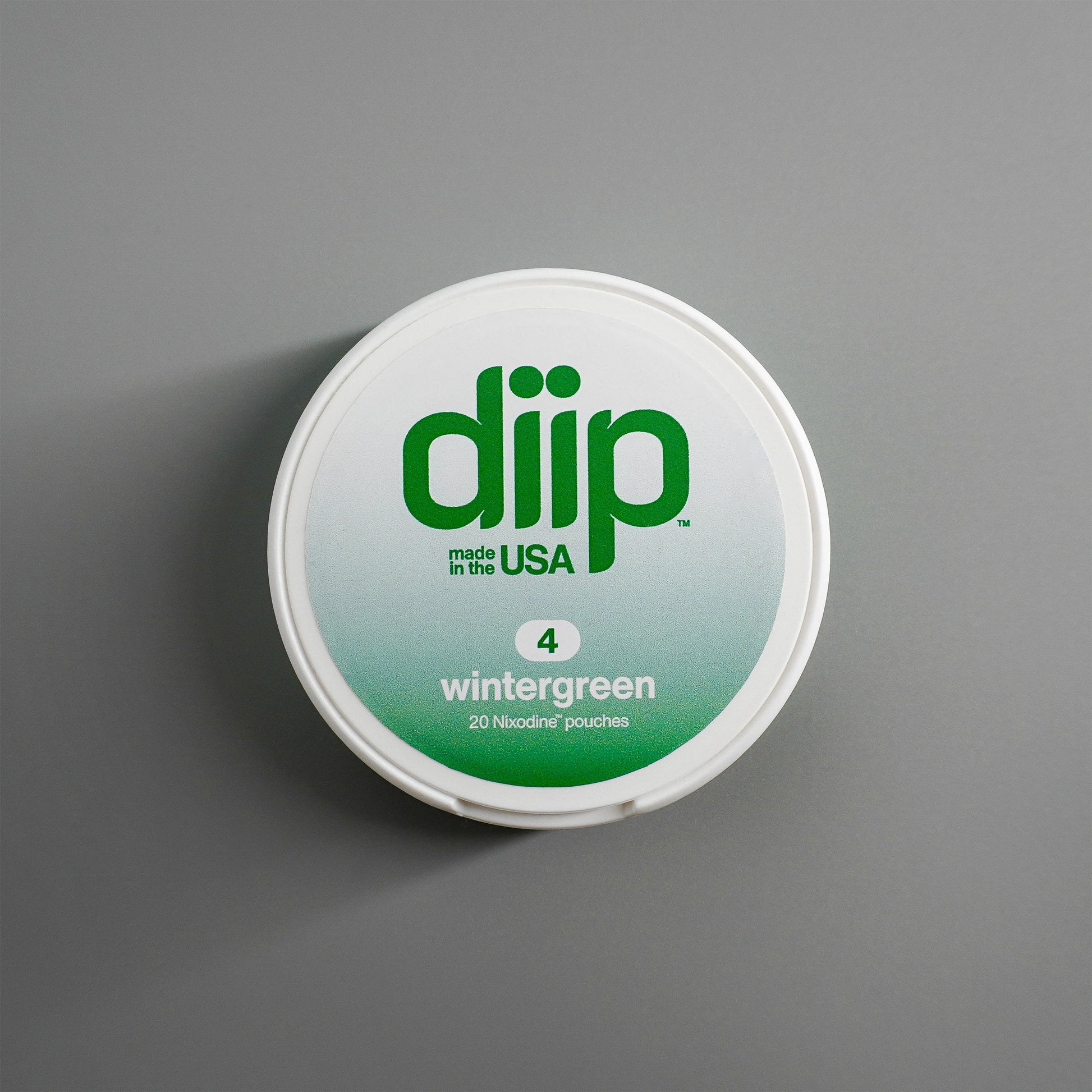 diip wintergreen 4 nicotine-free dip pouch can laying on a white background